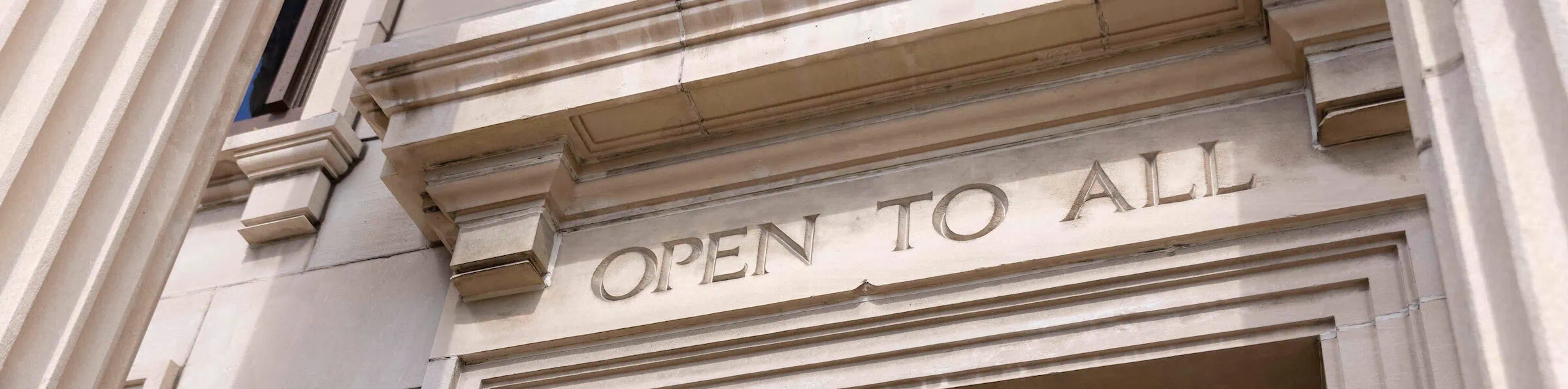 Open to all carved in the Bedell building