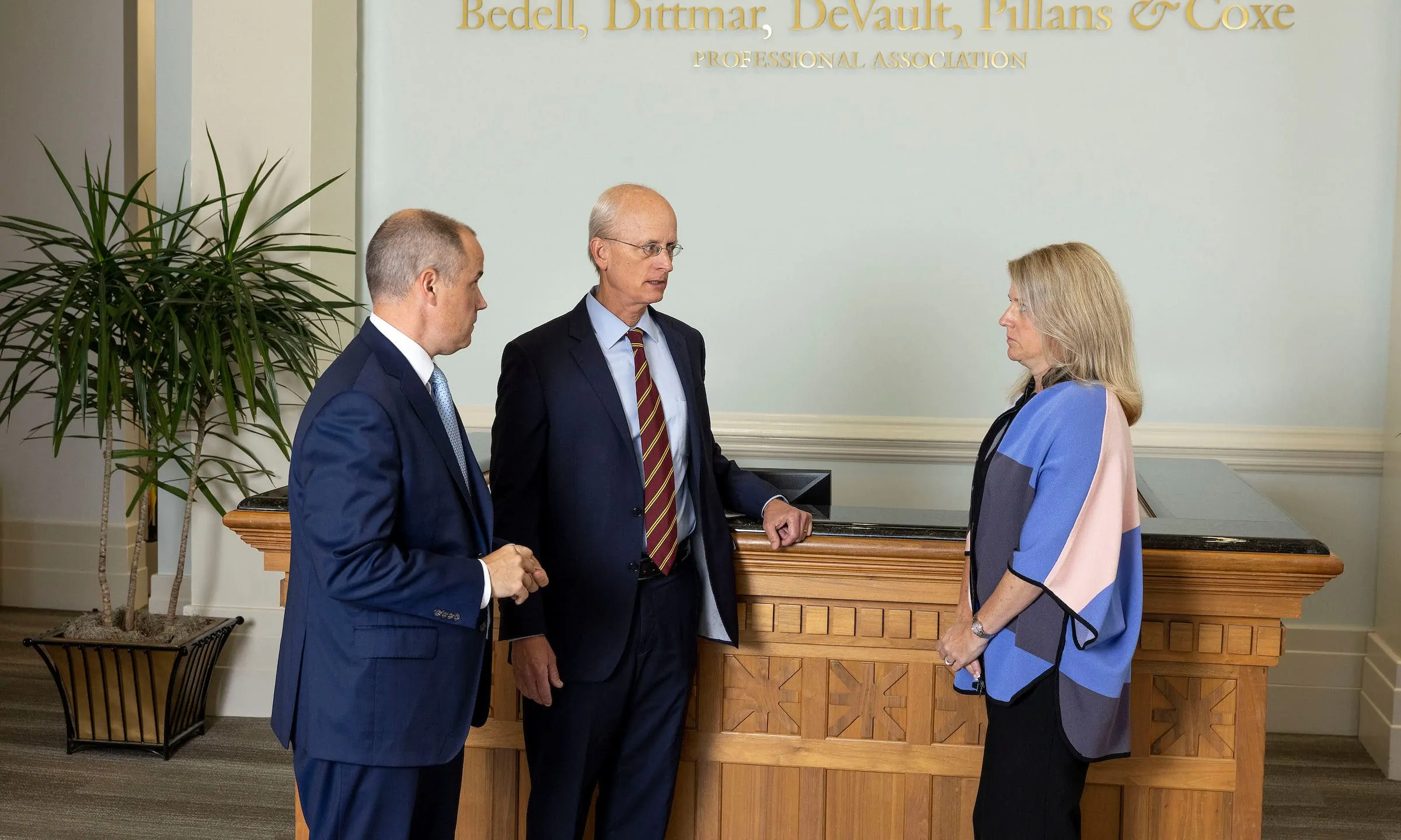 Attorneys standing at the entrance of Bedell Firm