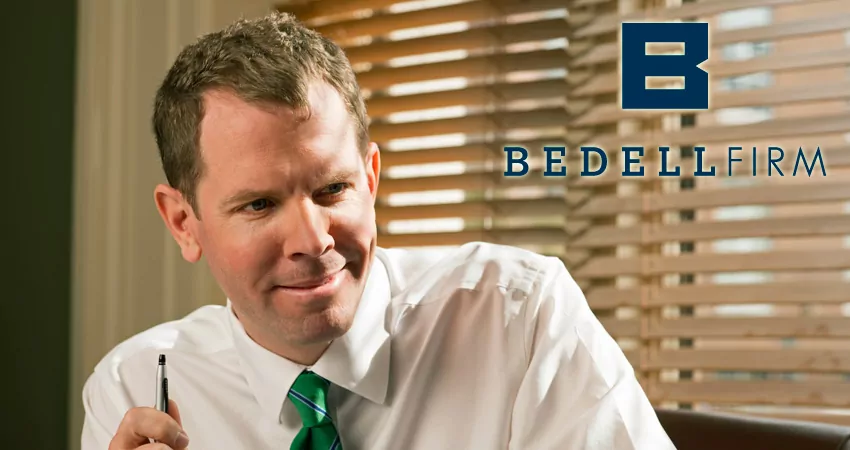 Brian Coughlin in a white button town in a green tie holding a pen. A blue Bedell Firm logo is shown to his right.