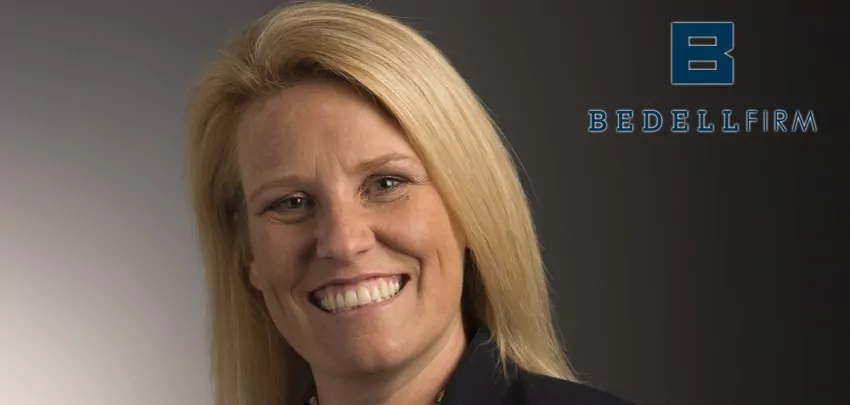 Ashley Wells Cox smiles. The blue Bedell Firm logo is to her right