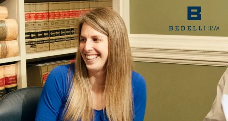 Erica L. Cruzat. a paralegal at the Bedell Firm, is smiling in an office