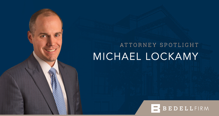 Attorney Michael Lockamy smiles. Text on image reads: "Attorney Spotlight: Michael Lockamy" and the Bedell Firm logo at the bottom