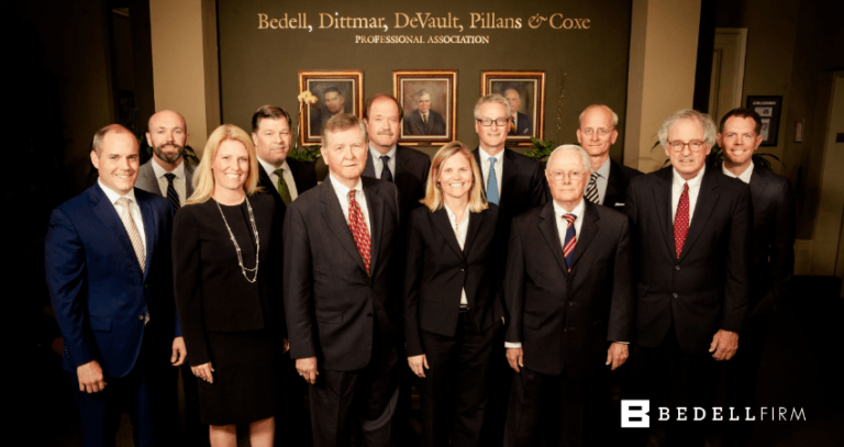 Attorneys and paralegals at Bedell Firm smile