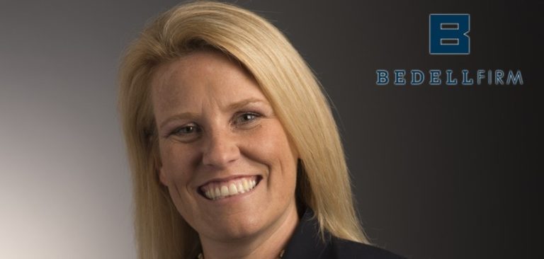 Ashley Cox smiles. The blue Bedell Firm logo is to her right