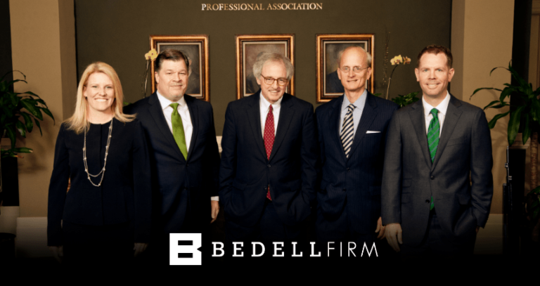 Bedell Firm attorneys stand and smile. The Bedell Firm logo is at the bottom