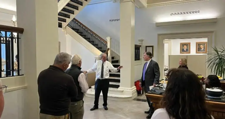 Hank Coxe speaking to a group of people in the Bedell building