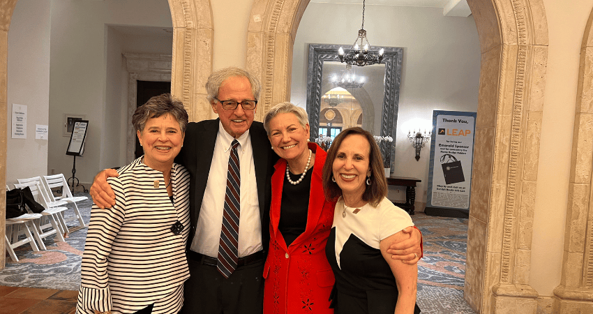 Hank Coxe smiling with people at convention