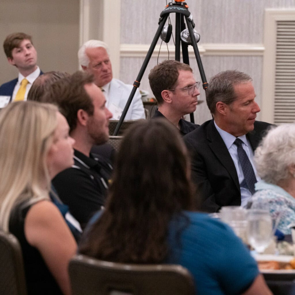 Brian sitting in a crowd at a JBA luncheon